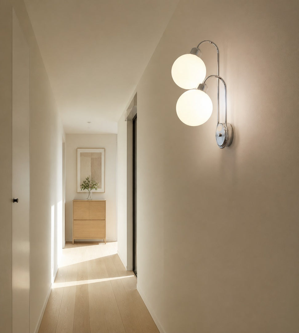 Milk coffee globe wall lamp mounted beside a bedroom nightstand