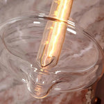 Cargar imagen en el visor de la Galería, Close view of the clear glass shade and warm bulb glow