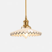 White pleated ceramic pendant light with brass-finish base