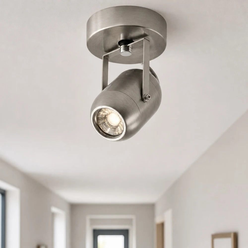 Adjustable wall lamp adding warm accent light near an entryway