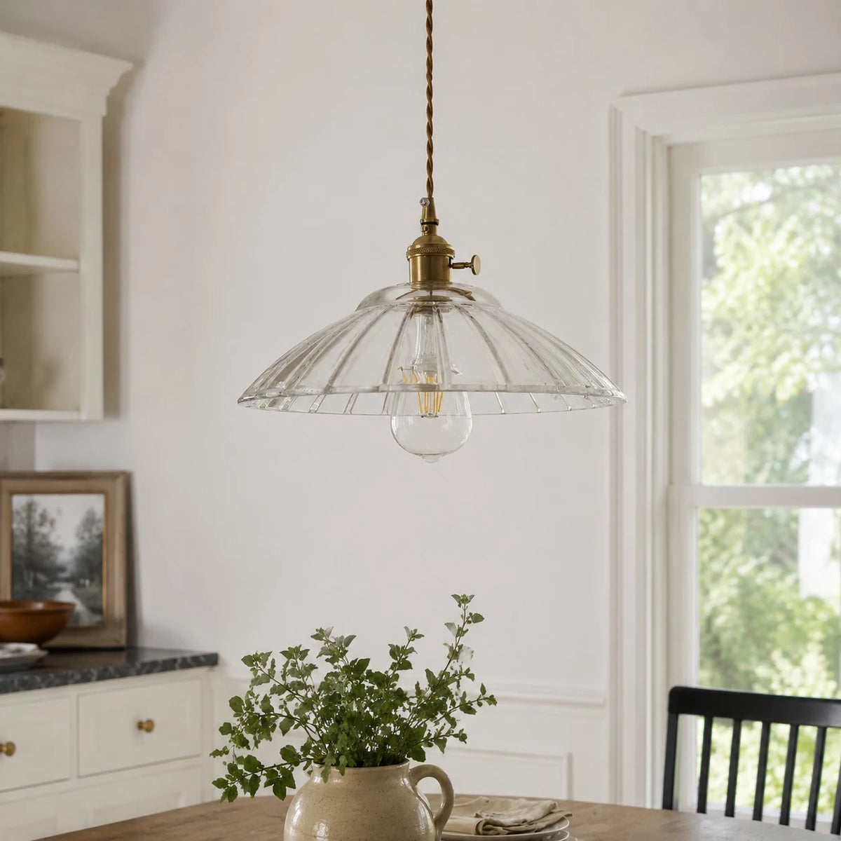 Transparent glass pendant installed over a dining table
