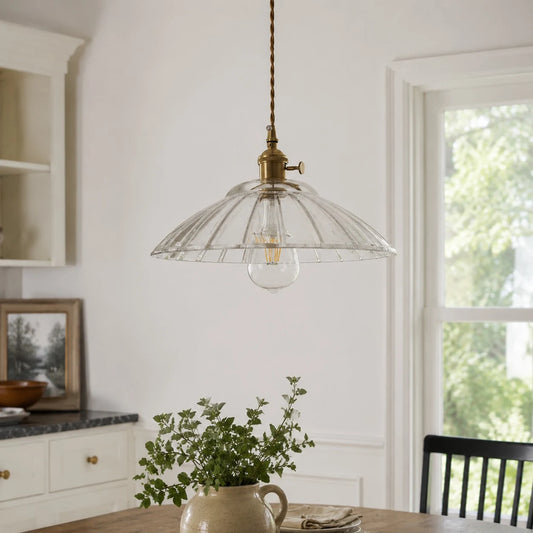 Transparent glass pendant installed over a dining table