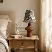 Blue floral ceramic table lamp on a bedside table