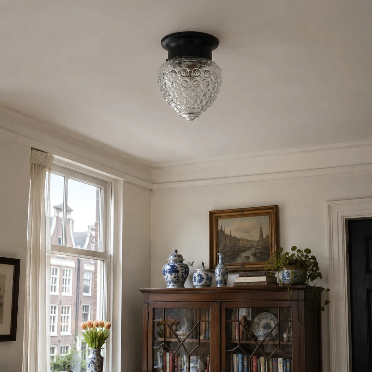 Glass ceiling lamp installed close to the ceiling in a classic room