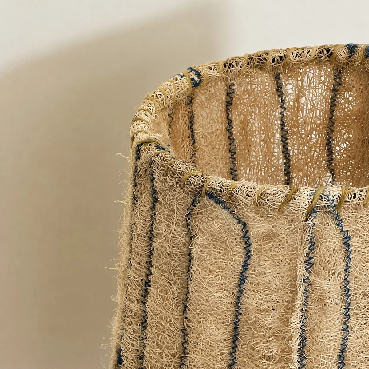 Black woven fiber table lamp on console