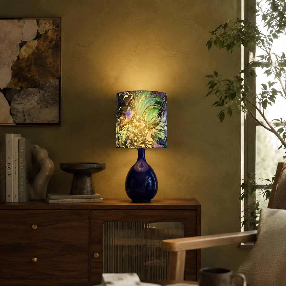 Green botanical fabric ceramic table lamp on a console table