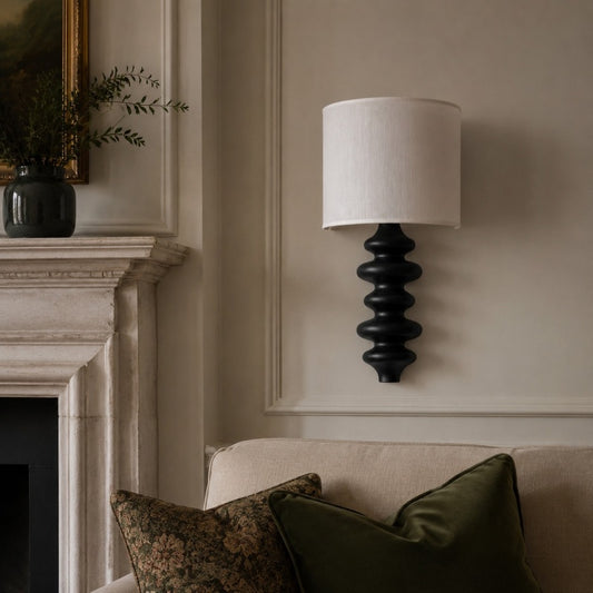 Ebony wall lamp installed beside a fireplace