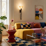 Załaduj obraz do przeglądarki galerii, Tall amber glass wall sconce in a colorful living room