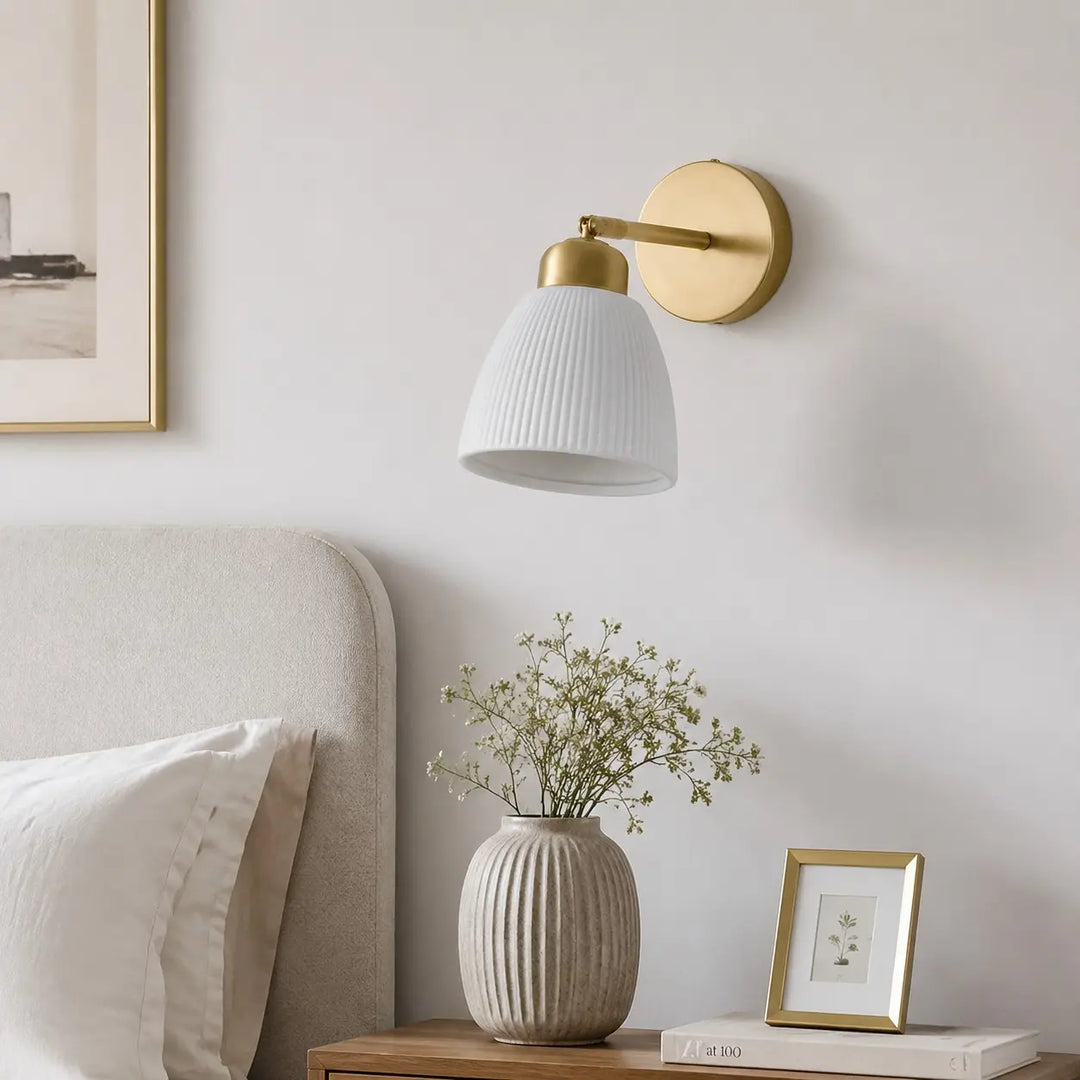 Ceramic wall light above a styled bedroom console