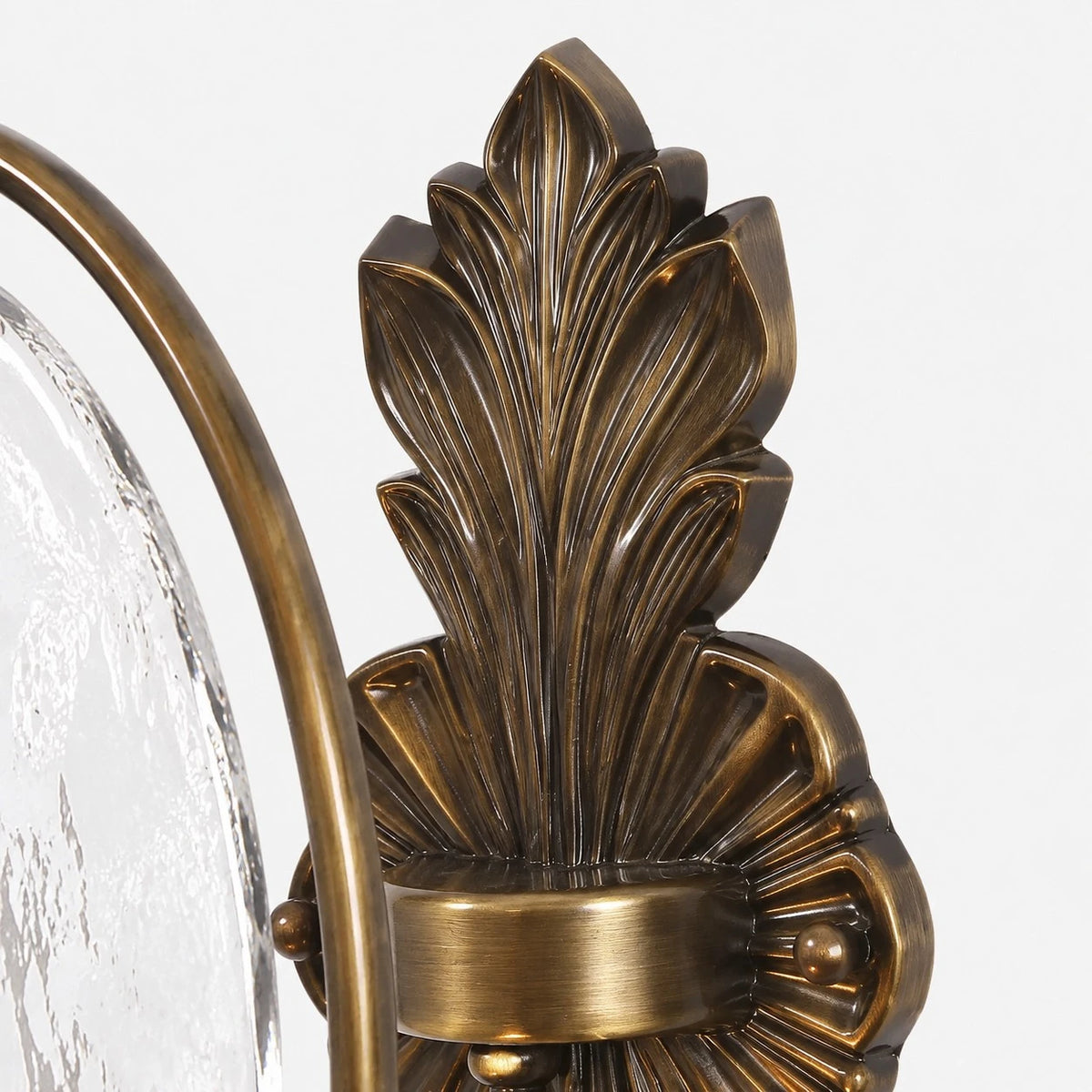 Close view of sculpted antique brass leaf backplate detail