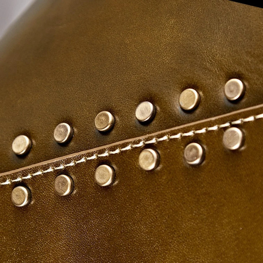 Close detail of brown leather shade with gold rivets