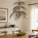 Cargar imagen en el visor de la Galería, Tiered silver palm leaf chandelier in a dining room