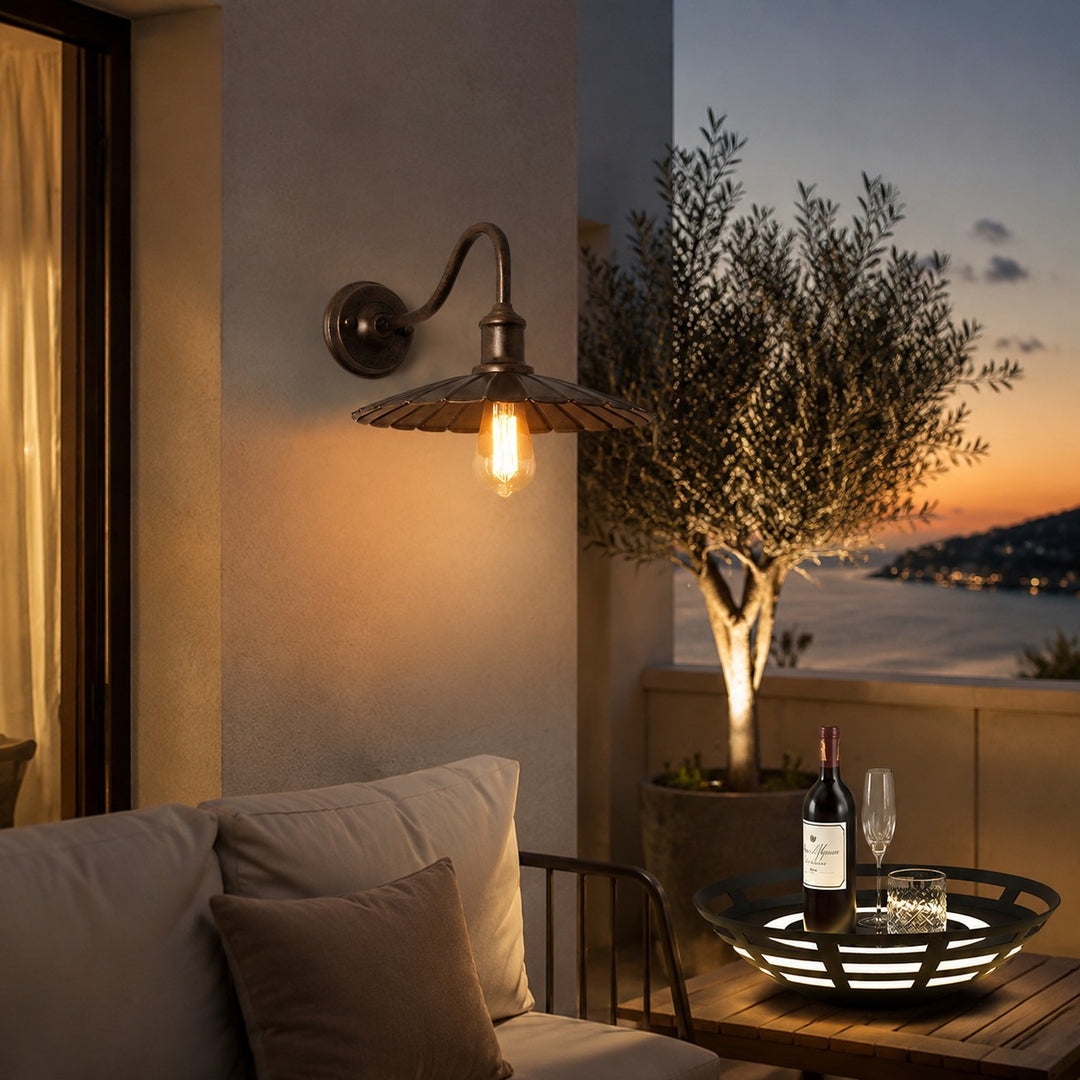Outdoor wall sconce on a terrace wall at dusk