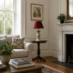 Afbeelding laden in galerijweergave, Red ceramic table lamp beside an armchair in daylight