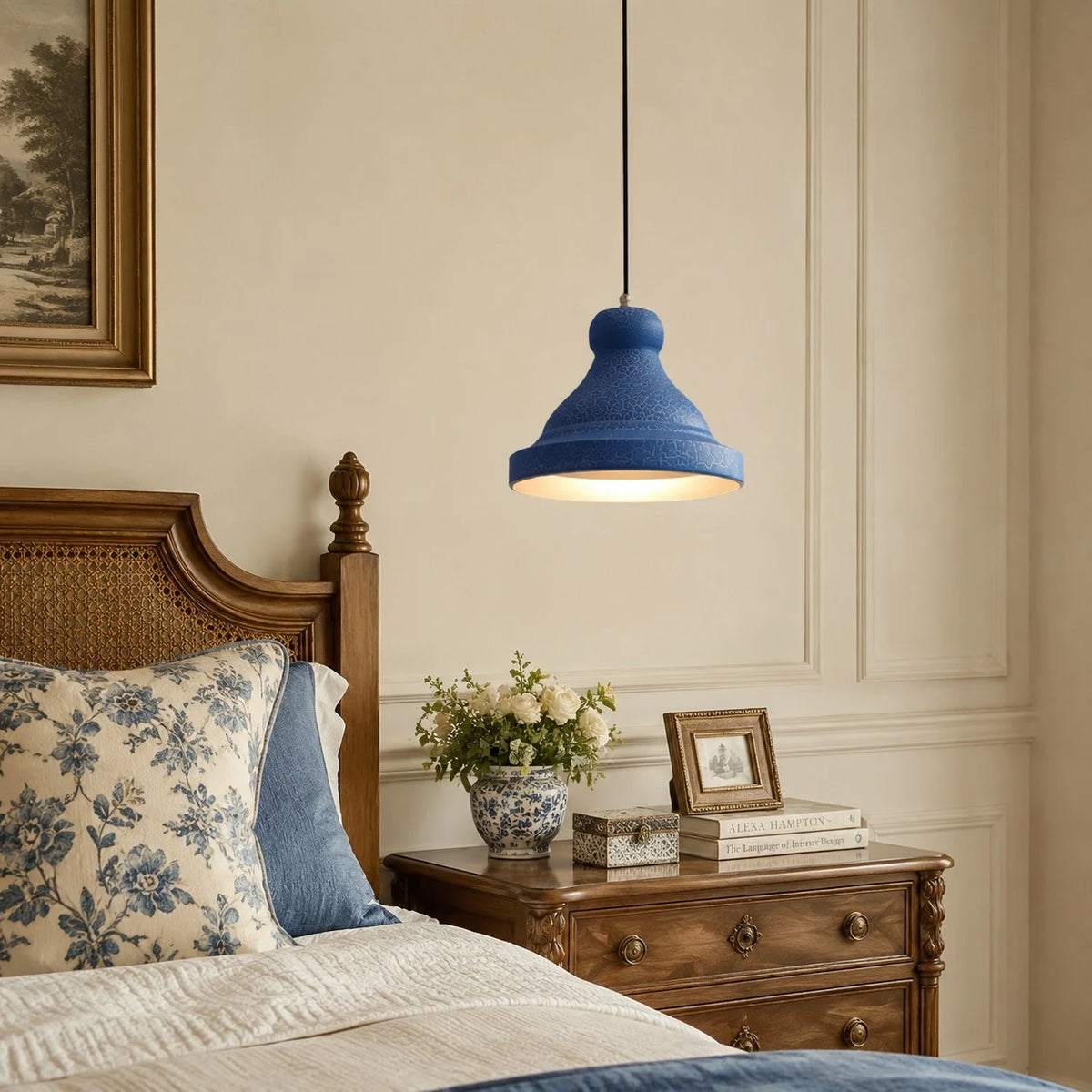 Blue metal pendant lamp beside a bedroom scene