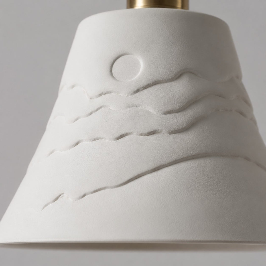 Raised sunset relief detail on the ceramic shade
