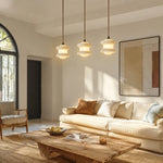 Cargar imagen en el visor de la Galería, Three-light travertine stone pendant in a warm living room