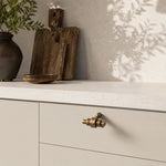 Afbeelding laden in galerijweergave, Antique brass cabinet handle in a warm modern interior