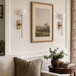 Bild in die Galerieansicht laden, Natural brass wall sconces over a sofa side table
