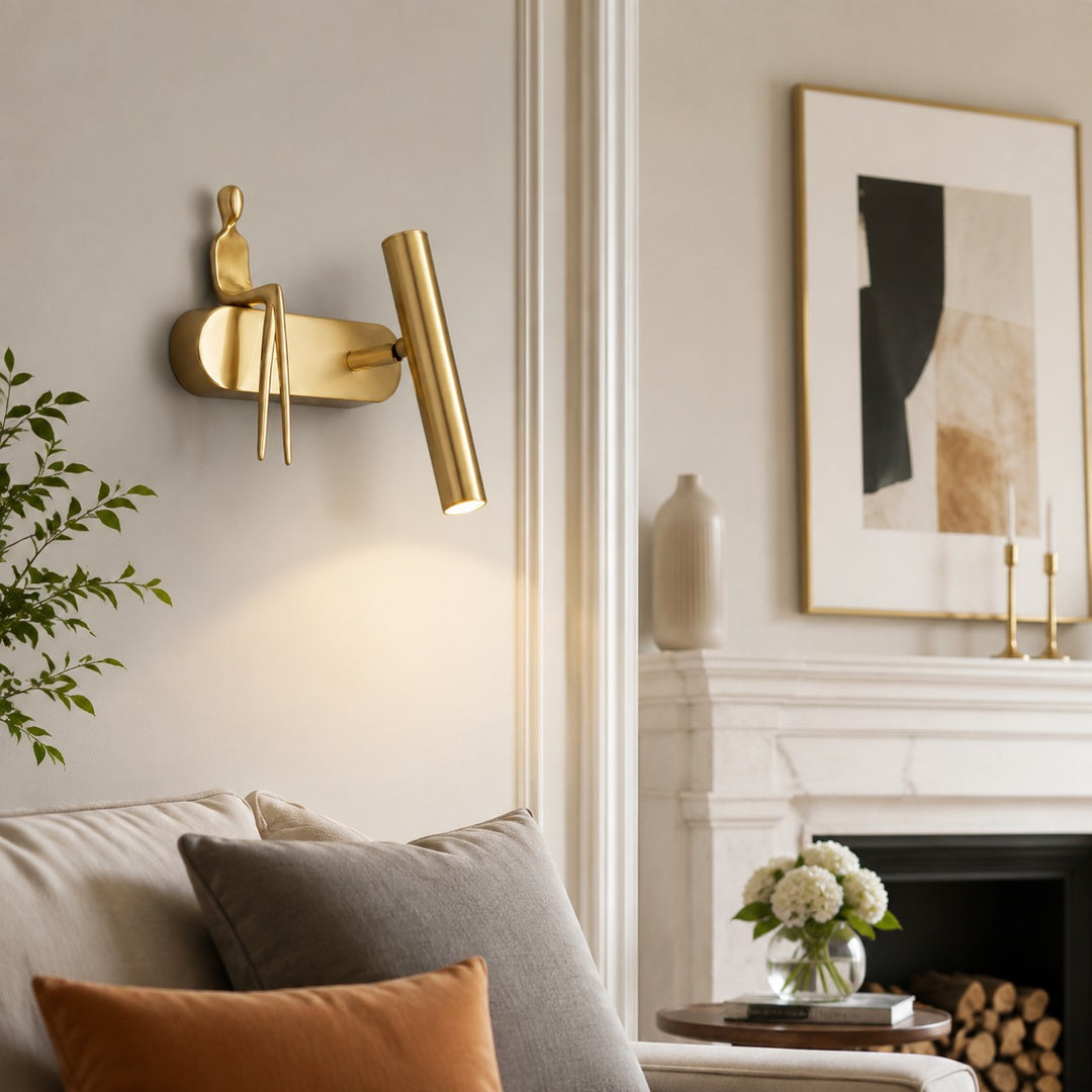 Wall sconce installed near framed art and seating