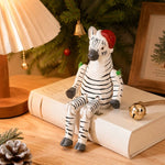 Bild in die Galerieansicht laden, Hand-carved wooden zebra with santa hat ornament styled on a tabletop edge
