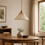 Load image into Gallery viewer, Pleated linen pendant light over a round wood dining table beside a bright window