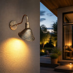 Załaduj obraz do przeglądarki galerii, Antique brass cone shade wall sconce on a covered exterior wall