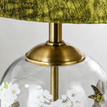 Load image into Gallery viewer, Close view of the brass tone hardware and glass lamp body