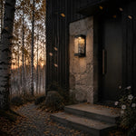 Załaduj obraz do przeglądarki galerii, Matte black outdoor wall light beside a modern entry door