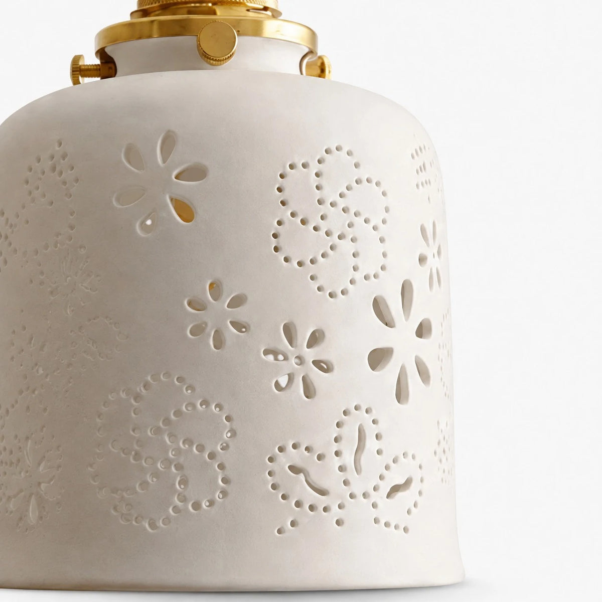 White ceramic lamp shade with perforated floral and dotted cutouts